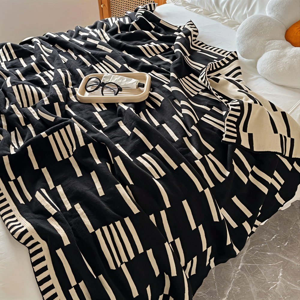 Strikket plaid i sort og beige akryl til sofa og seng