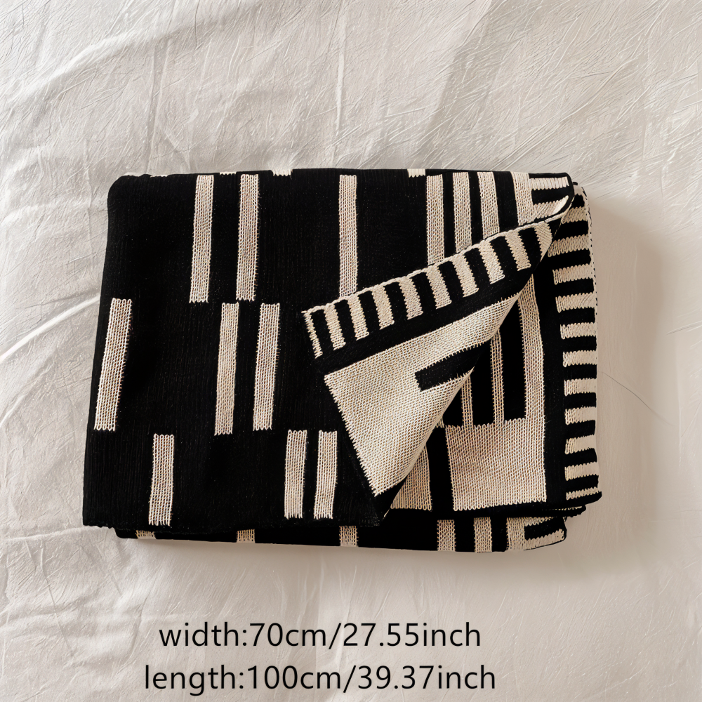 Strikket plaid i sort og beige akryl til sofa og seng
