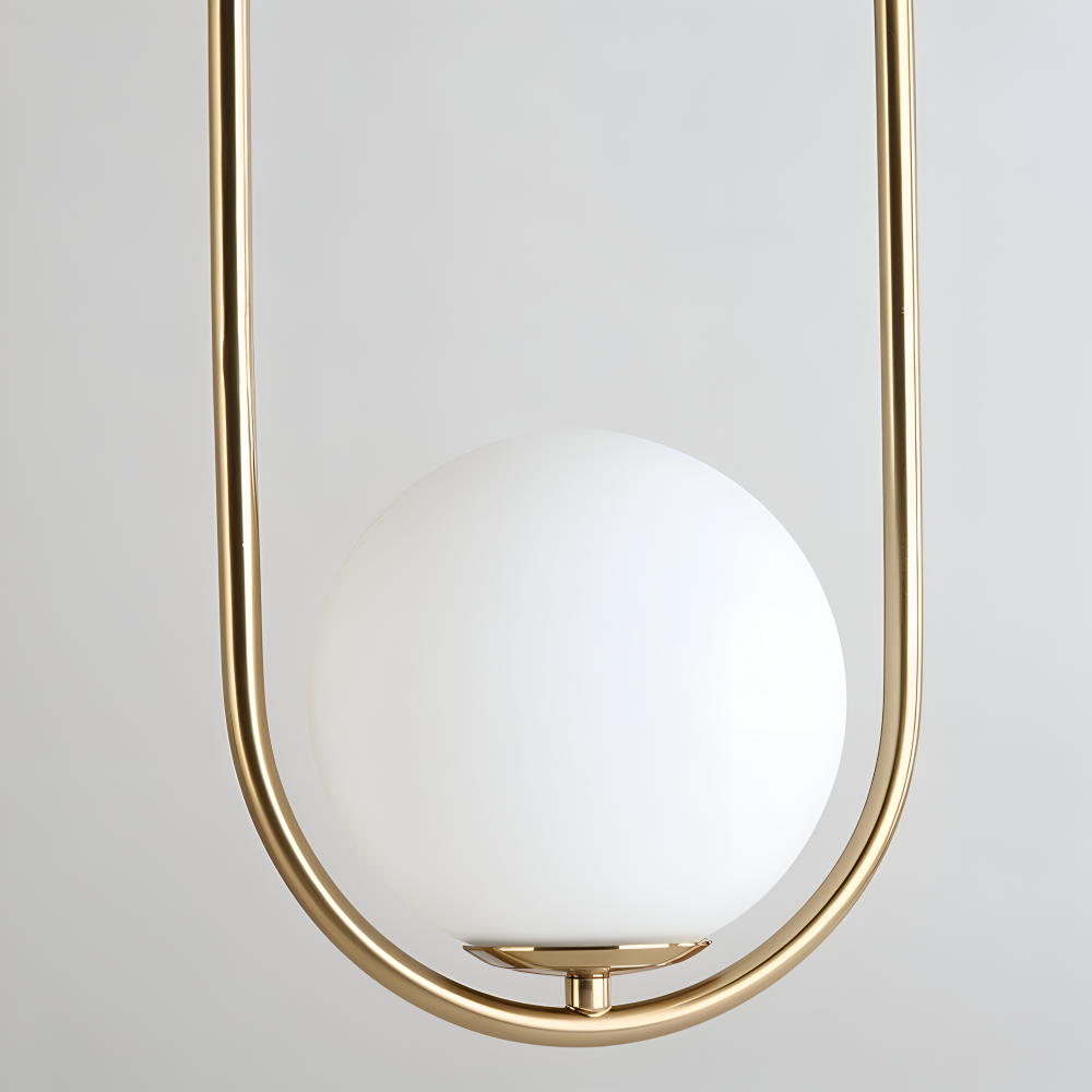 Moderne guld pendel lampe med glaskugle og ellipse design